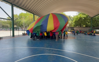 Children playing a team game with a SportsGuru coach