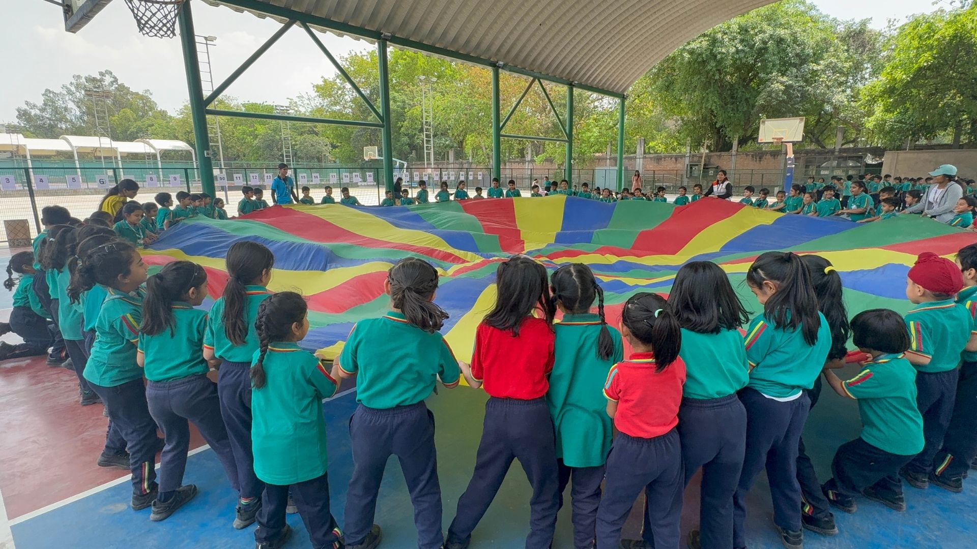 Children playing a team game with a SportsGuru coach