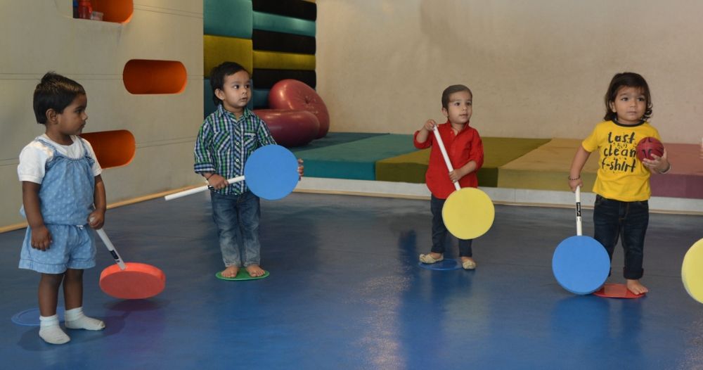 Young children participating in SportsGuru movement activities